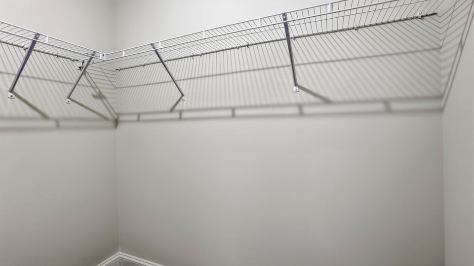 Closet with hanging storage rakcs.