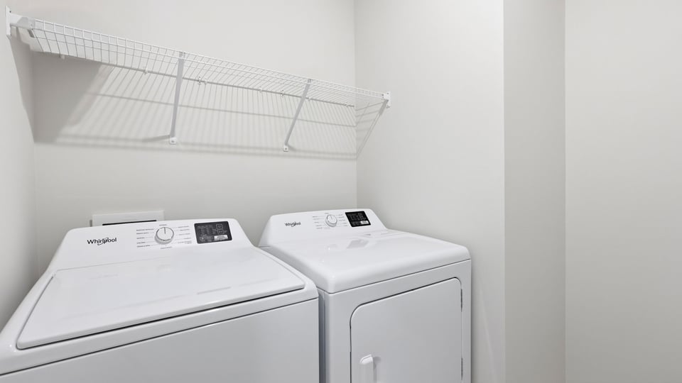 Laundry room with hanging storage racks.
