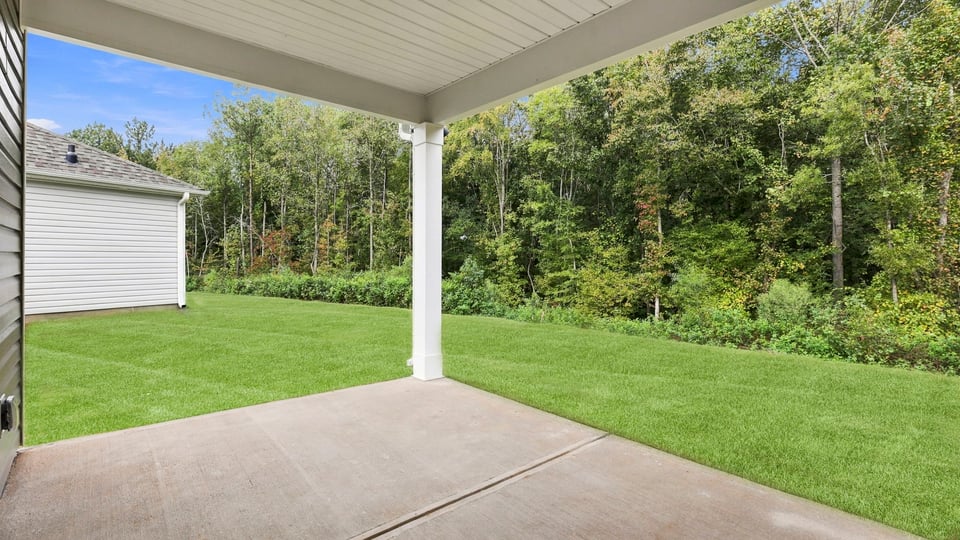 Back exterior of home with patio.