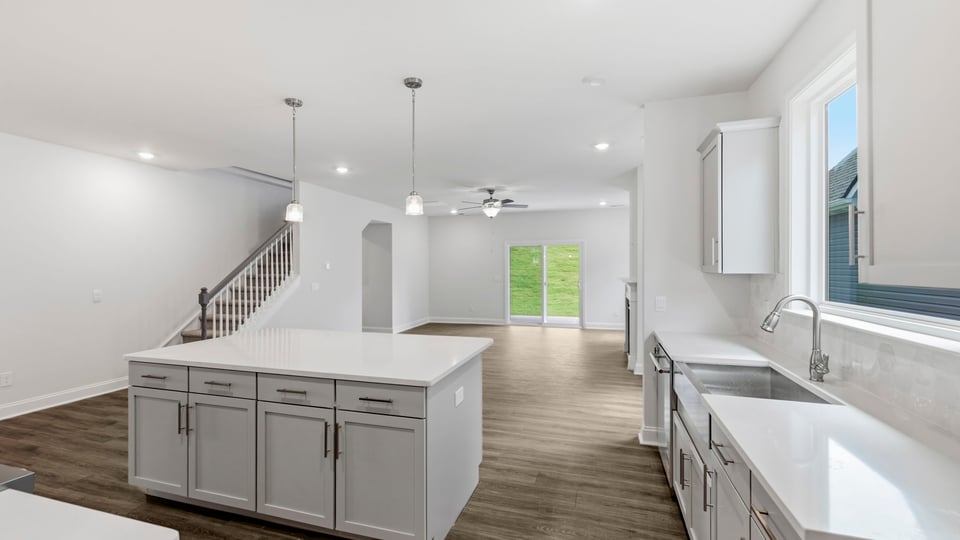 Kitchen and island with quartz countertops.