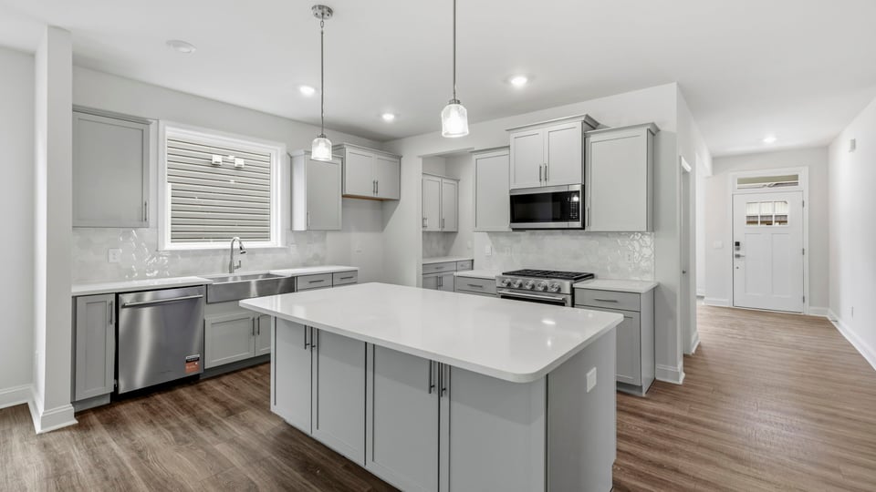 Kitchen and island with quartz countertops.