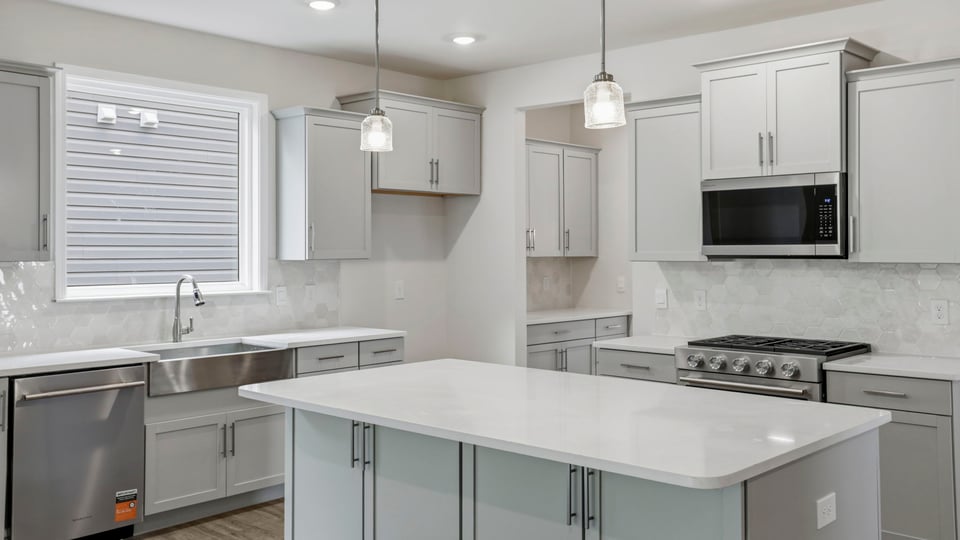 Kitchen and island with quartz countertops.
