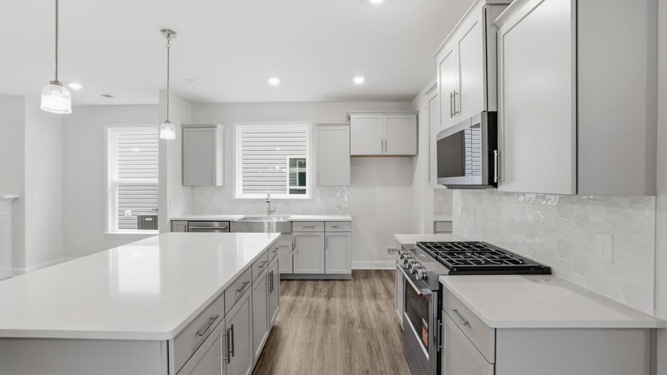 Kitchen and island with quartz countertops.