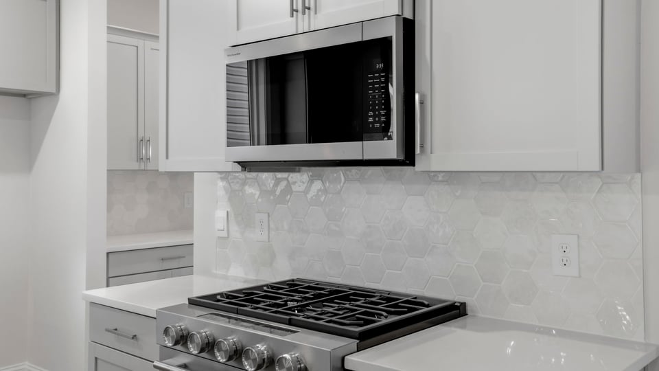 Kitchen and island with quartz countertops.