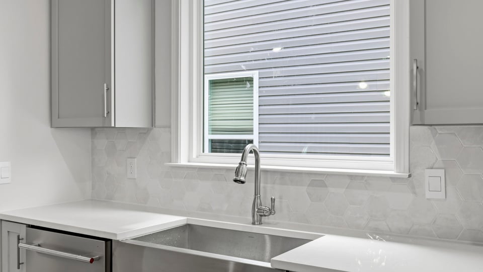 Kitchen and island with quartz countertops.