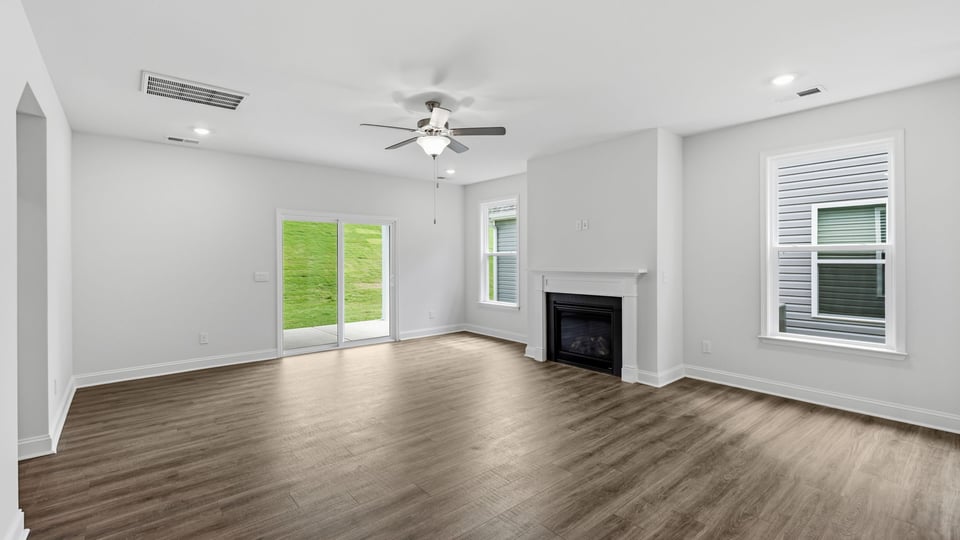 Living room with windows and fireplace.