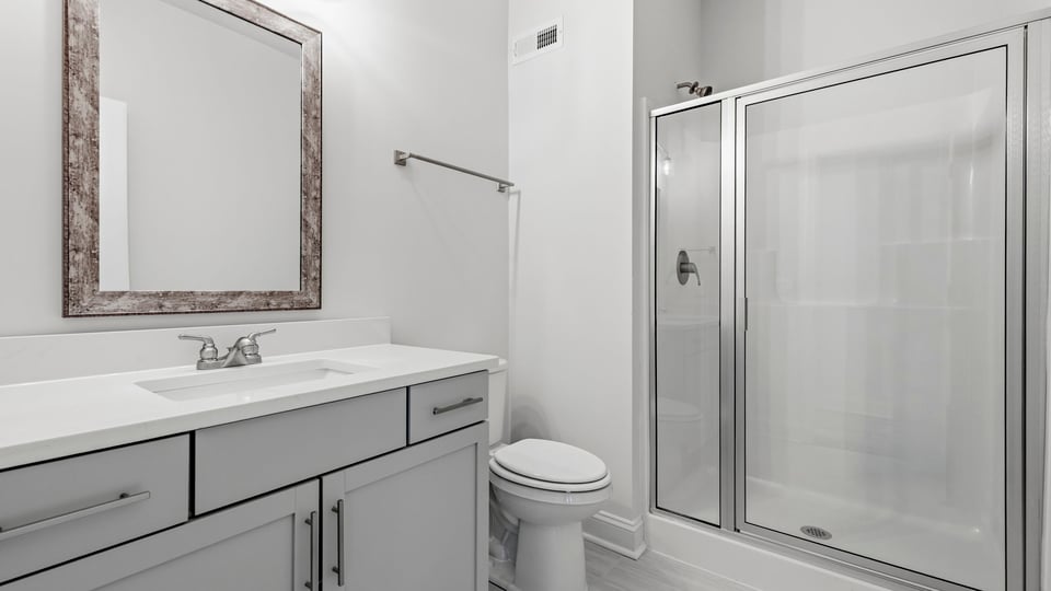 Bathroom with single vanity sink and walk in shower.