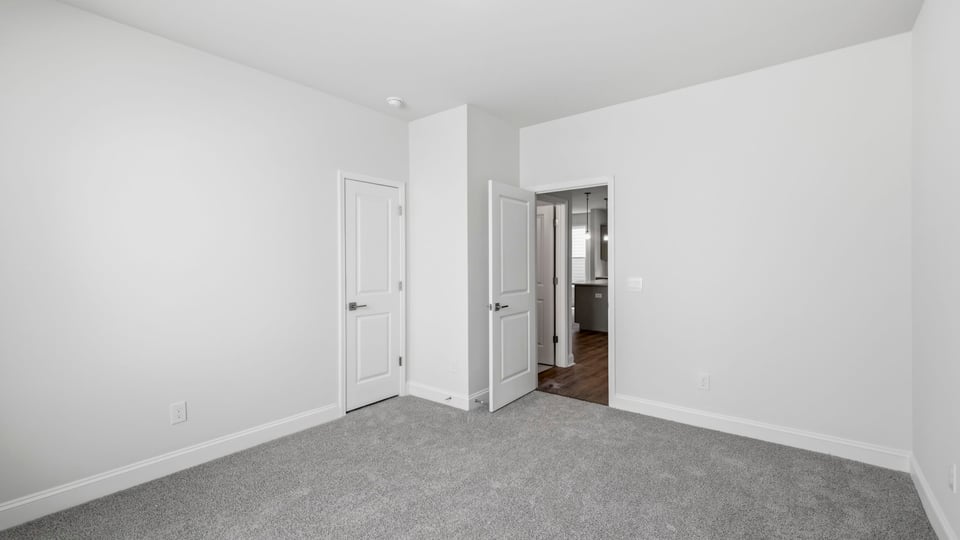 Bedroom with carpet and window.
