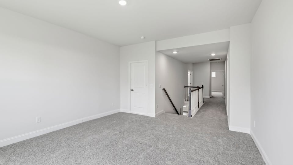 Bedroom with carpet and window.