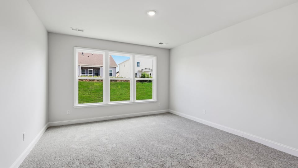 Bedroom with carpet and window.