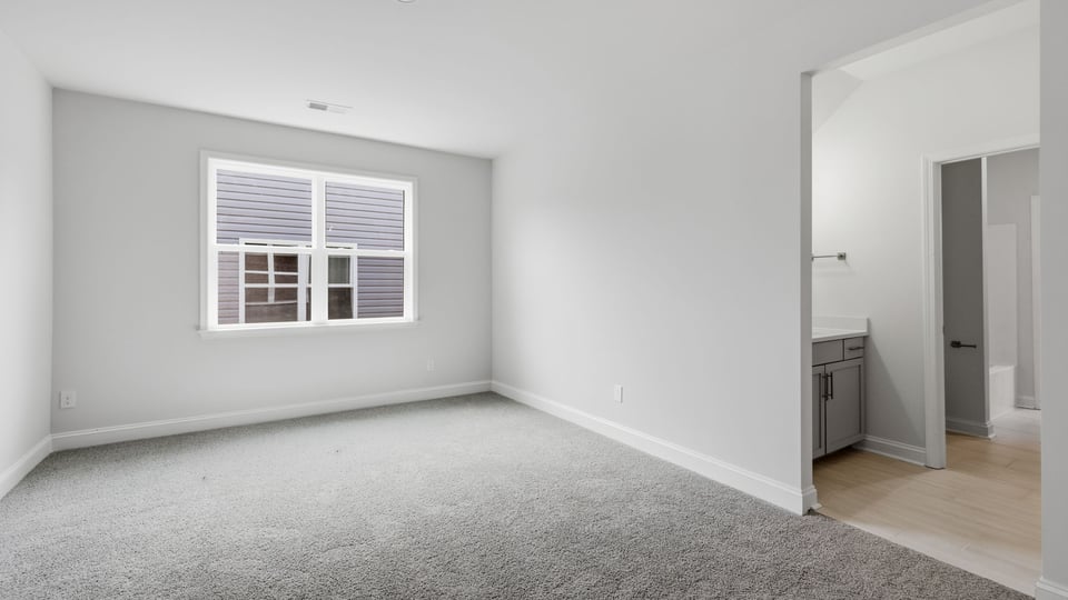 Bedroom with carpet and window.