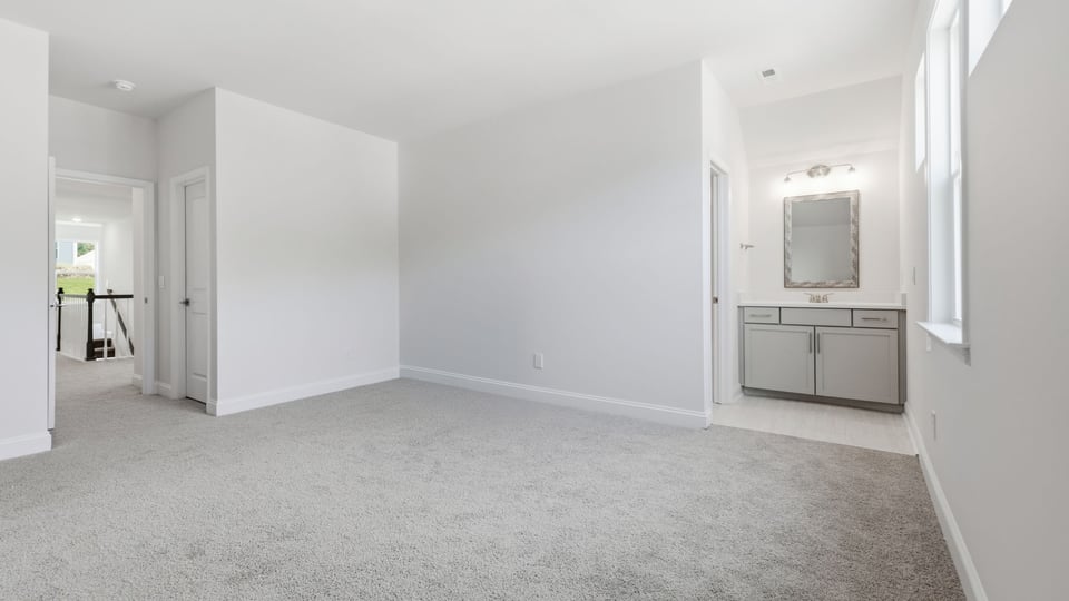 Bedroom with carpet and window.