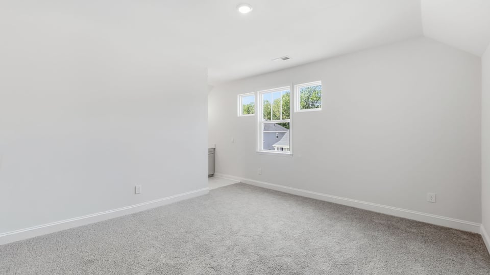 Bedroom with carpet and window.
