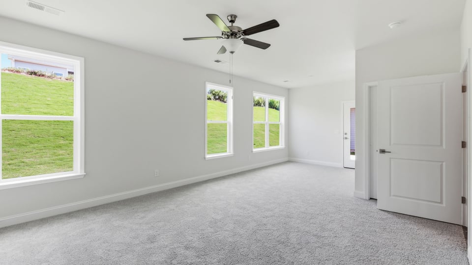 Bedroom with carpet and window.