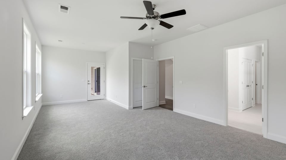 Bedroom with carpet and window.