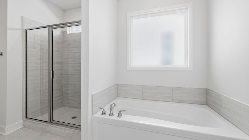 Bathroom with bathtub and walk in shower.