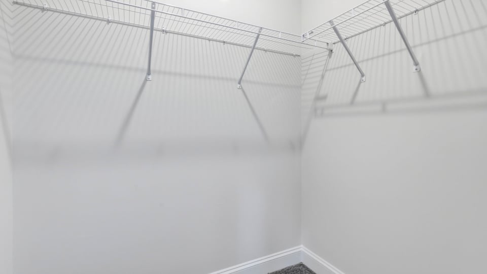 Closet with hanging storage racks.