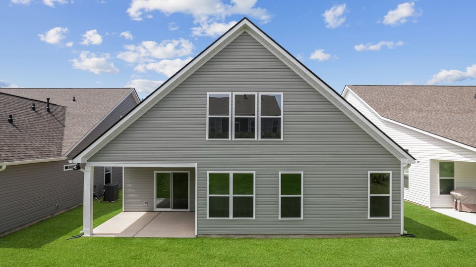 Back exterior of home with large backyard.