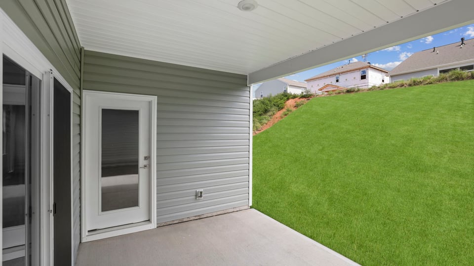Back exterior of home with patio.
