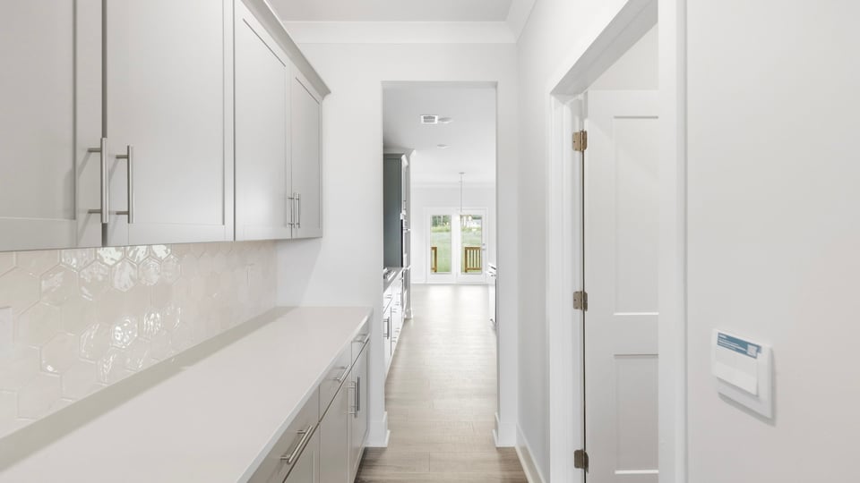 Butlers pantry with quartz countertops.