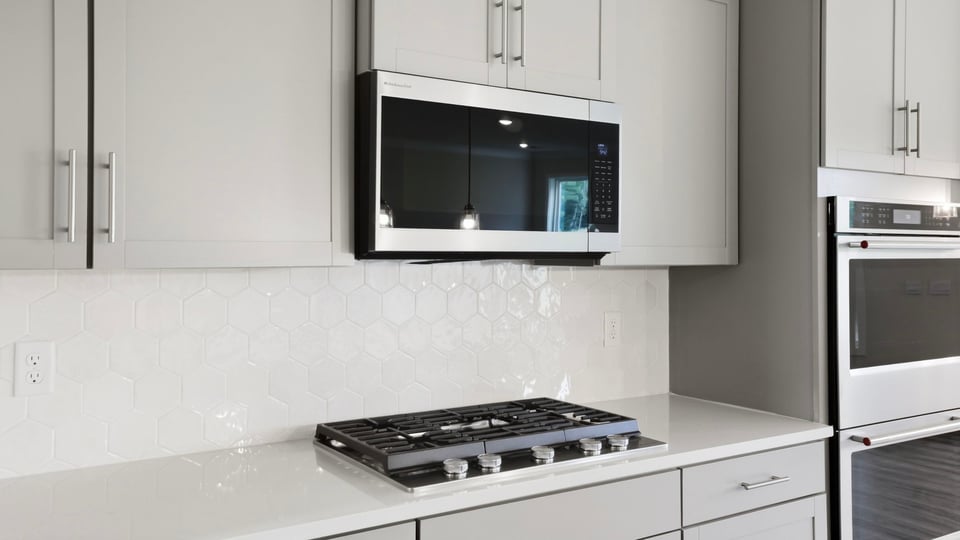Kitchen and island with quartz countertops.