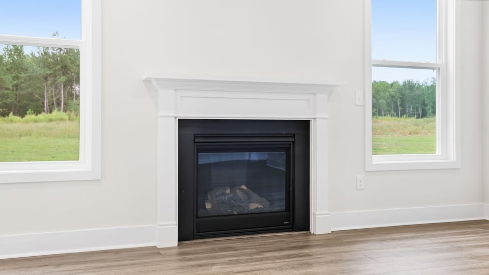 Living room with windows and fireplace.