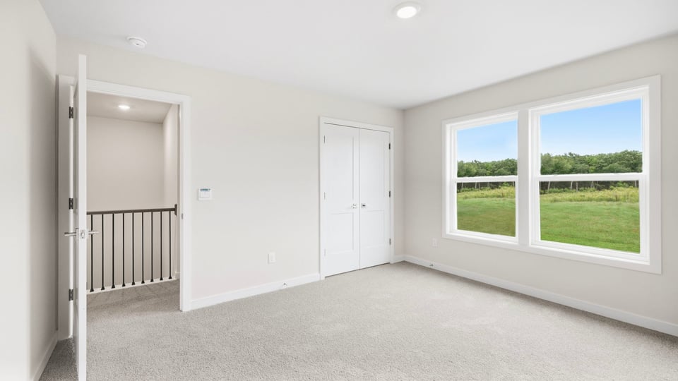 Bedroom with carpet and window.