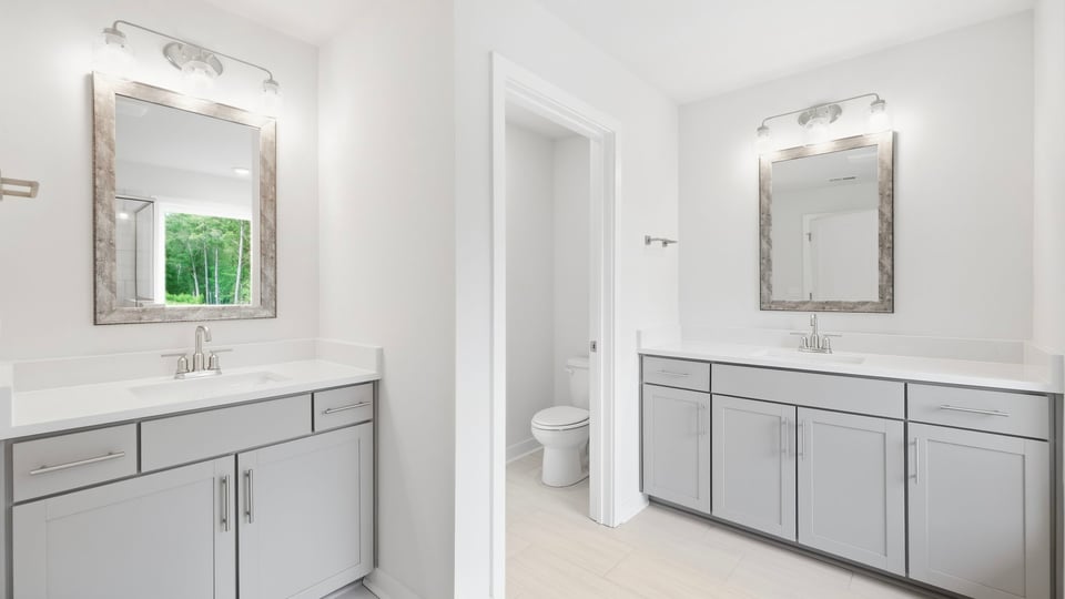 Bathroom with double vanity sink and window.