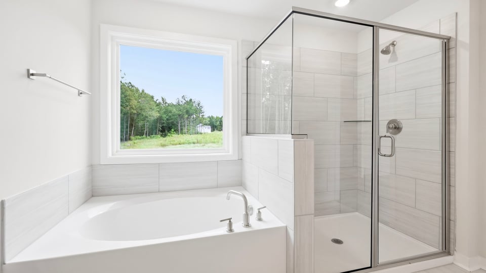 Bathroom with bathtub and walk in shower.