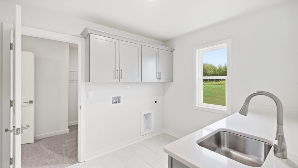 Laundry room with sink and window.