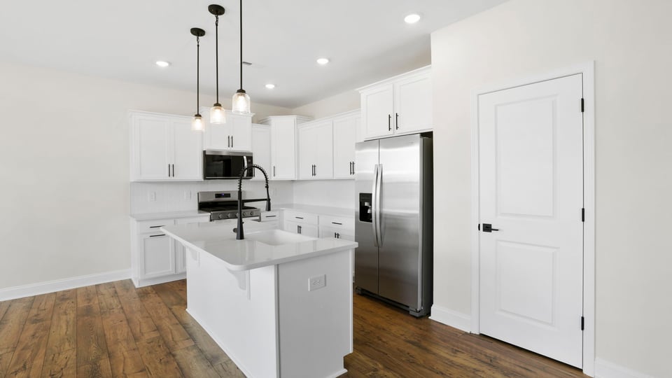 Kitchen with island and cabinets.