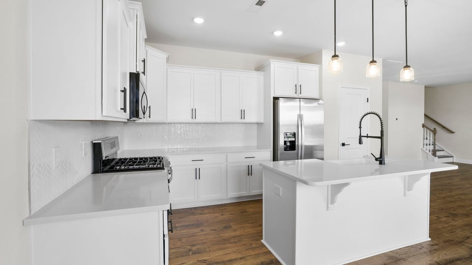 Kitchen with island and cabinets.