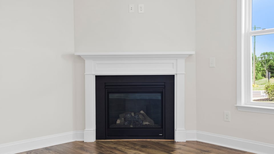 Living area with windows and fireplace.