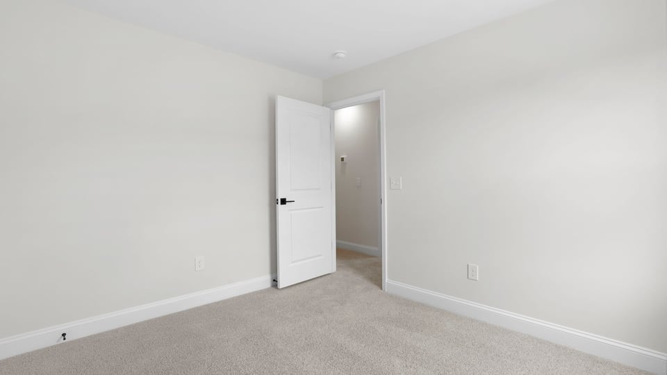 Bedroom with carpet and window.