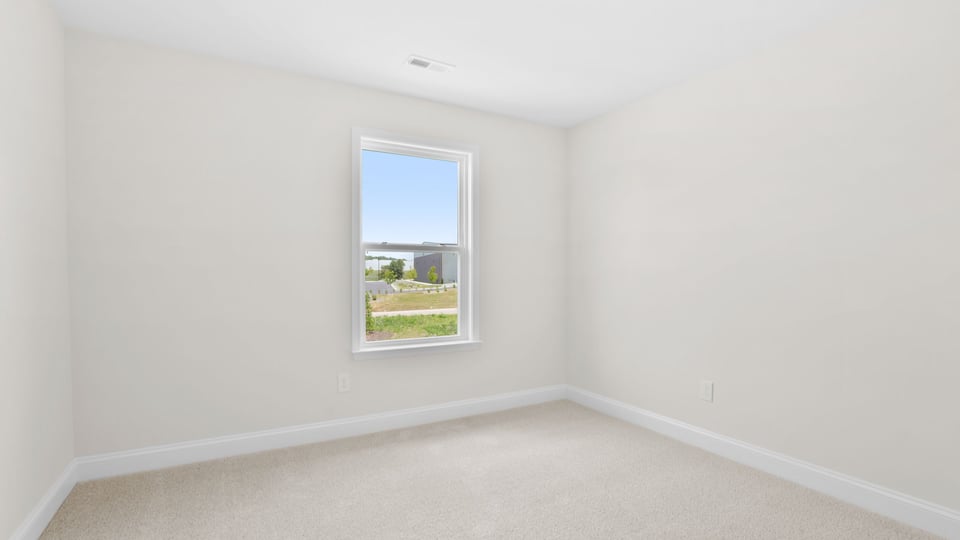 Bedroom with carpet and window.