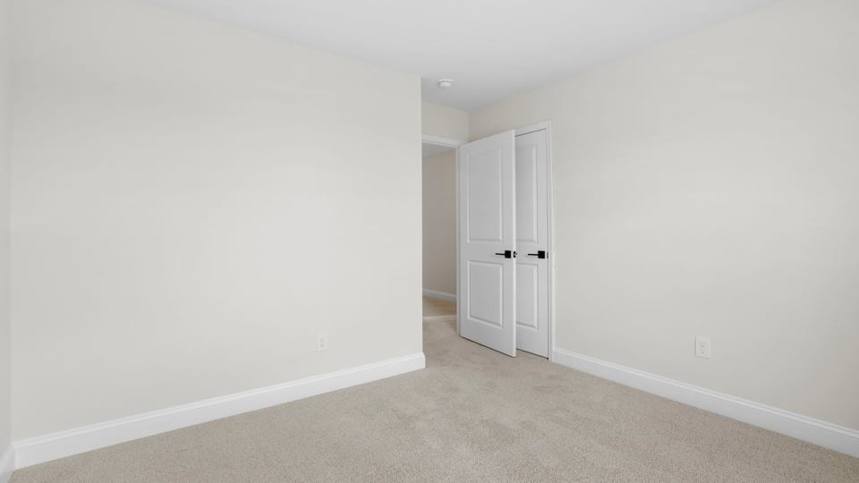 Bedroom with carpet and window.
