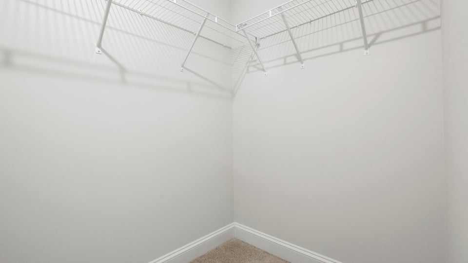 Primary closet with shelf.