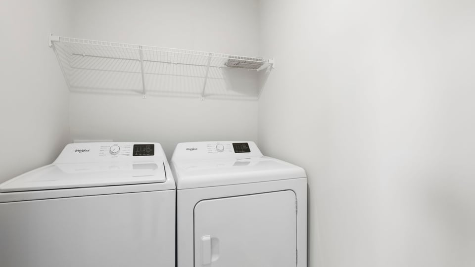 Laundry room with shelf.