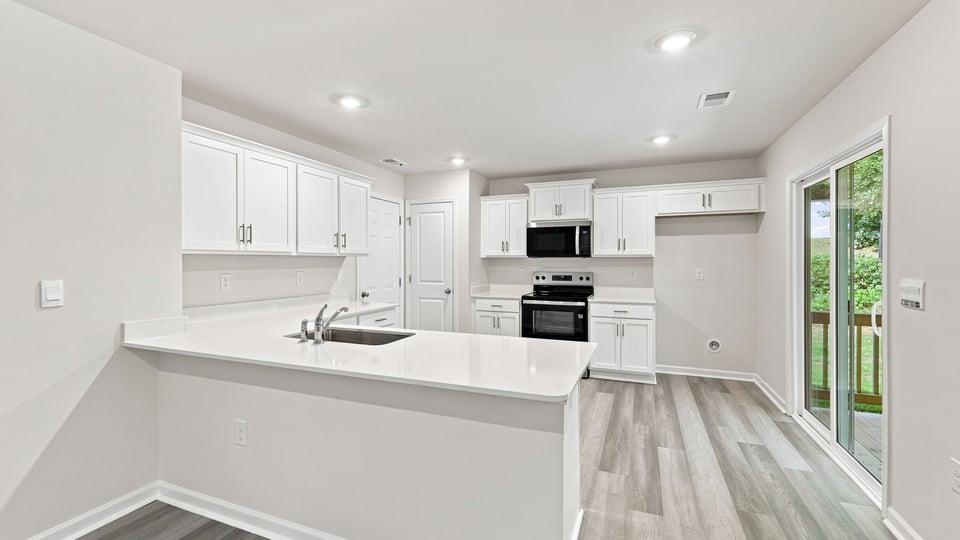 Kitchen with cabinets and windows.