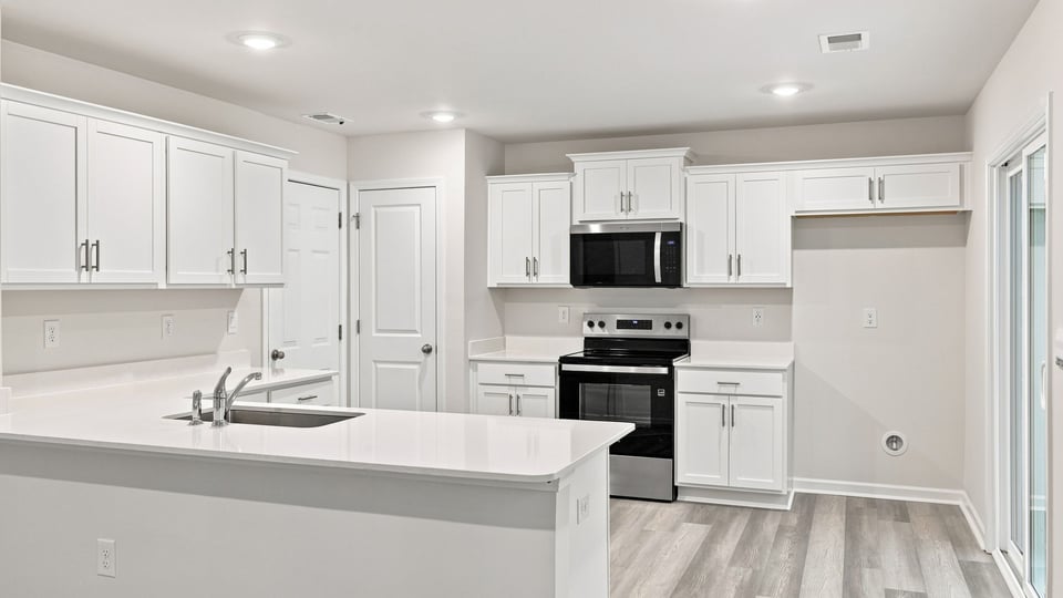 Kitchen with cabinets and windows.