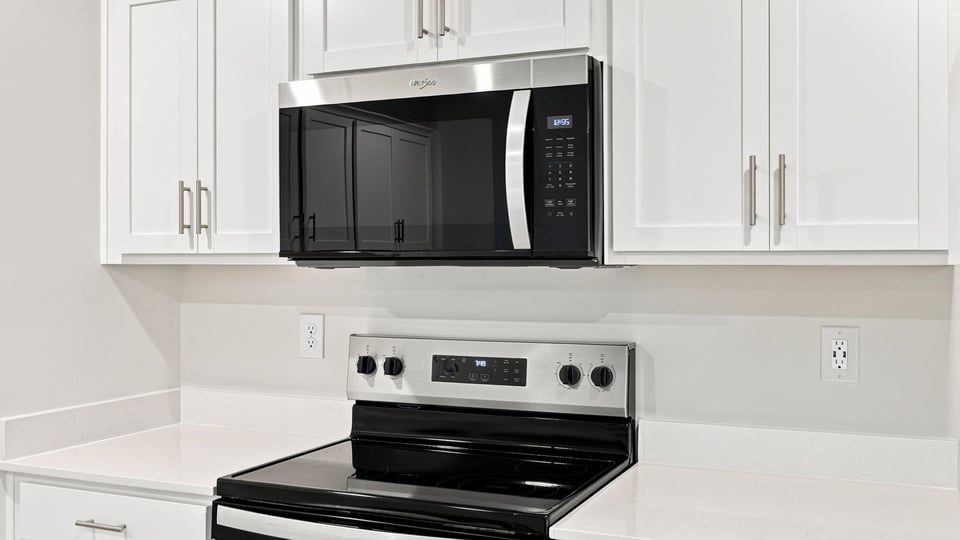 Kitchen with cabinets and windows.