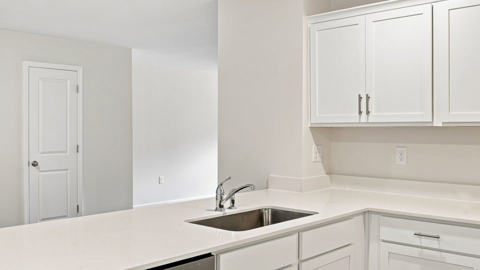 Kitchen with cabinets and windows.