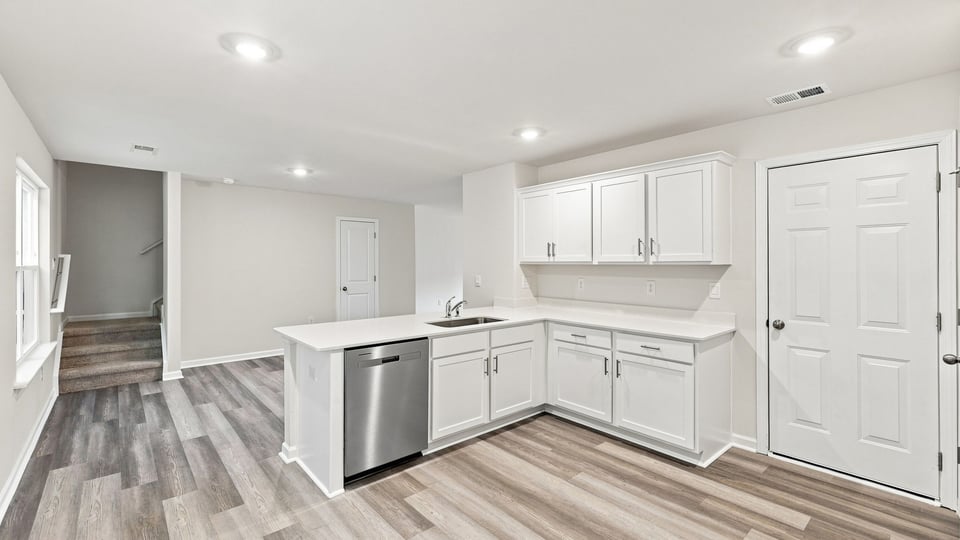 Kitchen with cabinets and windows.