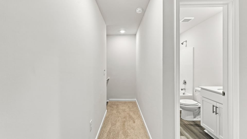Hallway to bathrooms.a