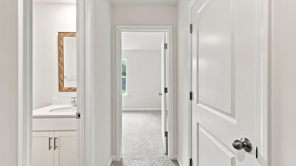 Hallway to bathrooms.a