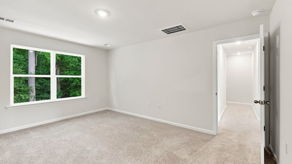 Bedroom with carpet and windows.