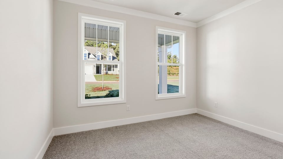 Bedroom with carpet and window.