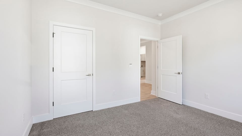 Bedroom with carpet and window.