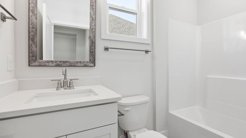 Bathroom with single vanity sink and bathtub.