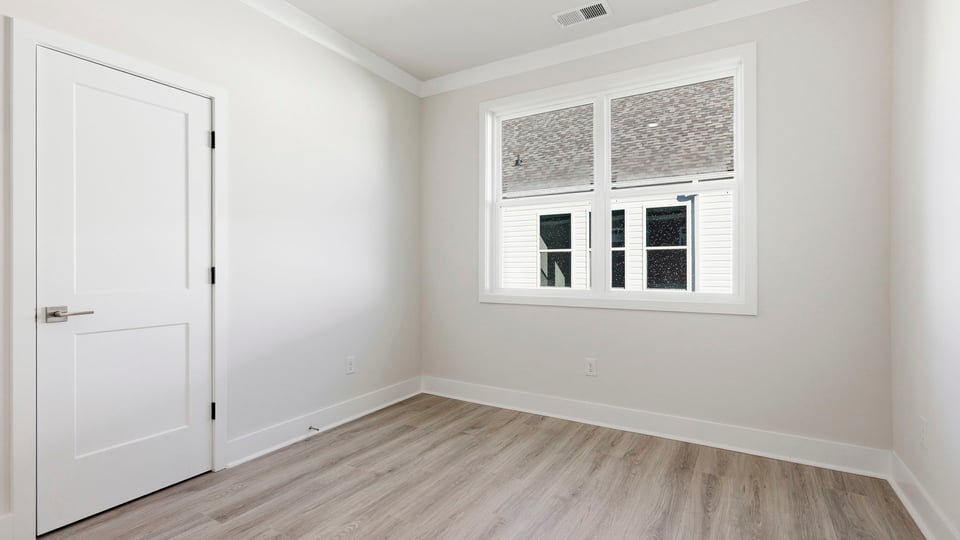 Bedroom with carpet and window.